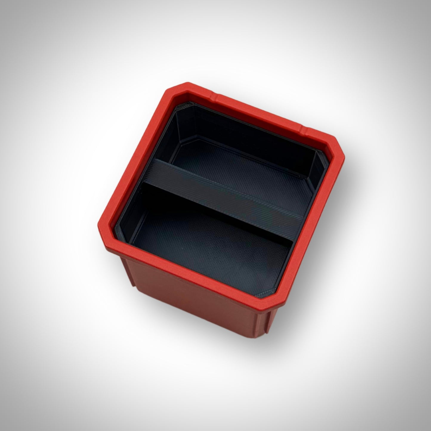 Empty double stack bin dividers installed inside the Milwaukee PACKOUT™ Medium Organiser, showing their secure fit and compartment design.