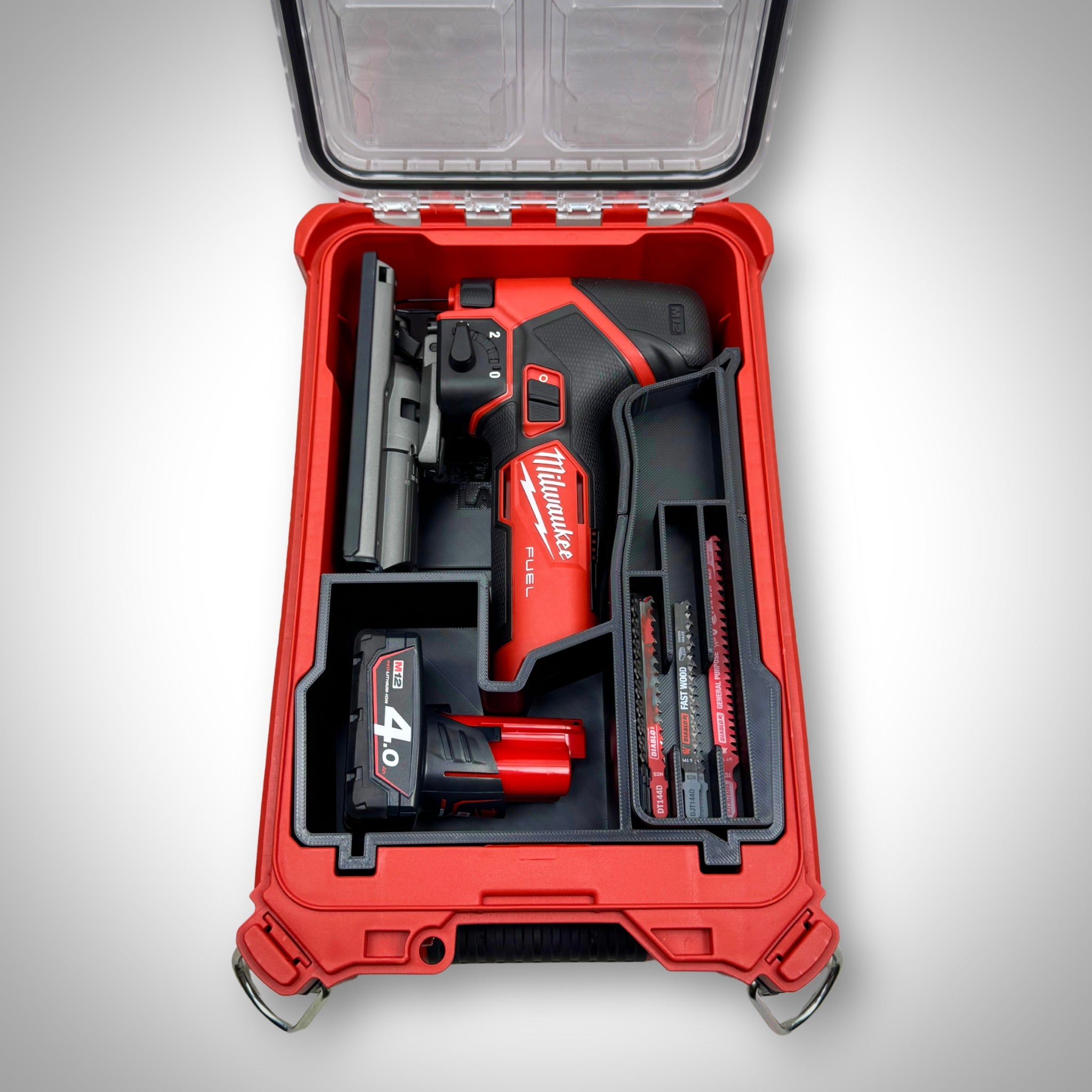 Milwaukee PACKOUT Compact Organiser with custom insert securely holding the M12 FUEL Jigsaw and accessories, all neatly arranged inside the container.