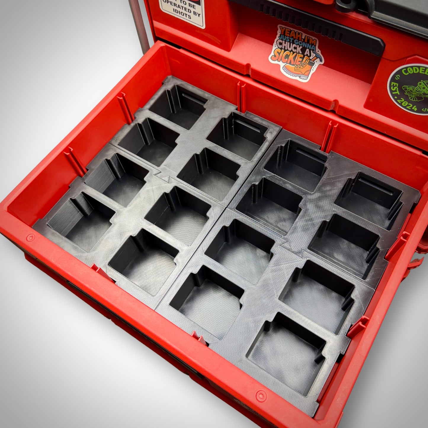 Two Makita 18V Battery Storage Inserts empty and placed securely inside the Milwaukee PACKOUT™ Two-Drawer Toolbox, showing the clean compartment layout.