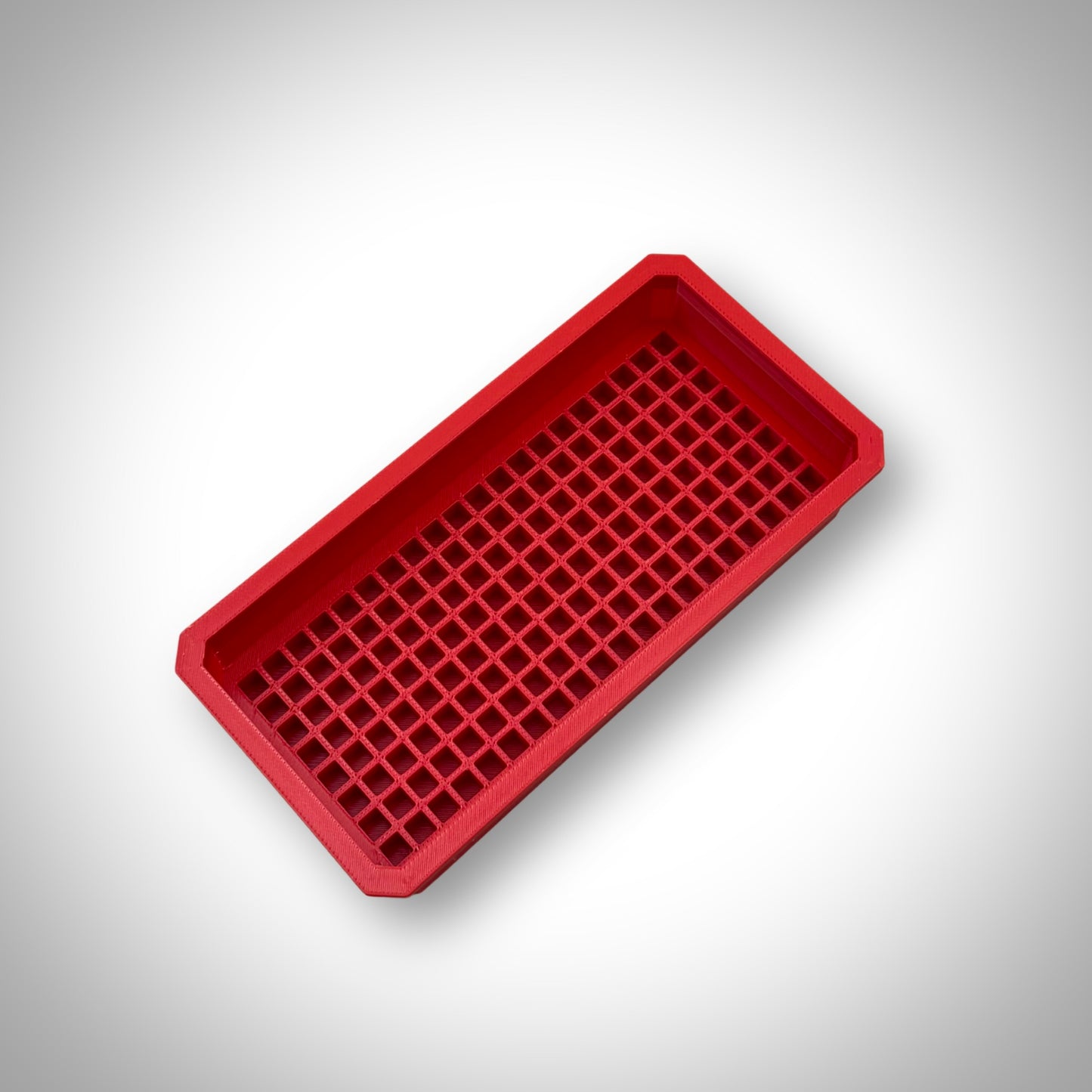 Red Impact Bit Holder insert displayed outside the Milwaukee PACKOUT™ Low Profile Organiser, showcasing durable design and bit slots.