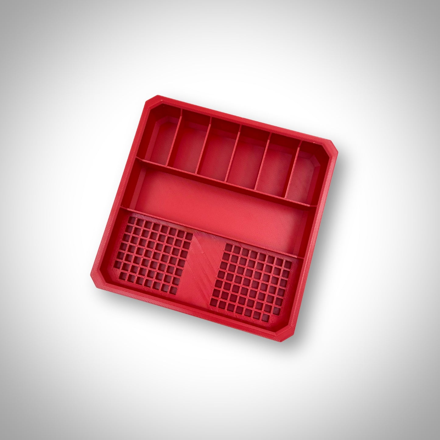 Empty red Impact Bit Holder V2 displayed outside the Milwaukee PACKOUT™ Low Profile Organiser, highlighting the durable design and precise moulding.