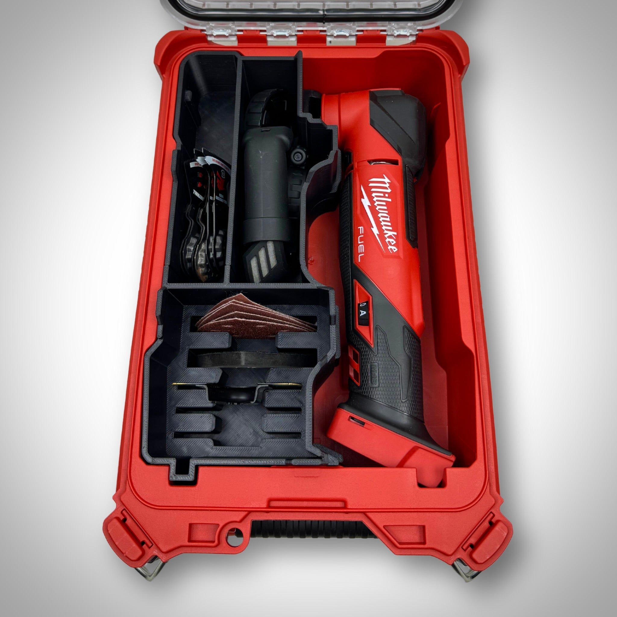 M18 Multi Tool and its blades, sanding pads, and accessories neatly arranged in the custom insert inside the Milwaukee PACKOUT™ Compact Organiser.
