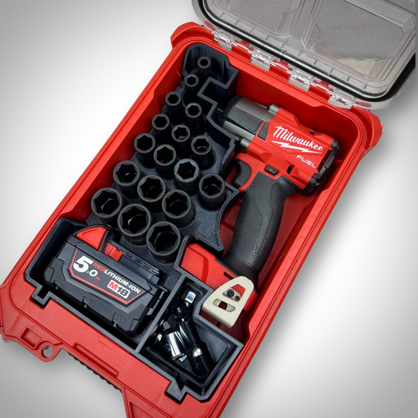 M18 1/2" Impact Wrench and full socket kit neatly arranged in the custom insert inside the Milwaukee PACKOUT™ Compact Organiser.