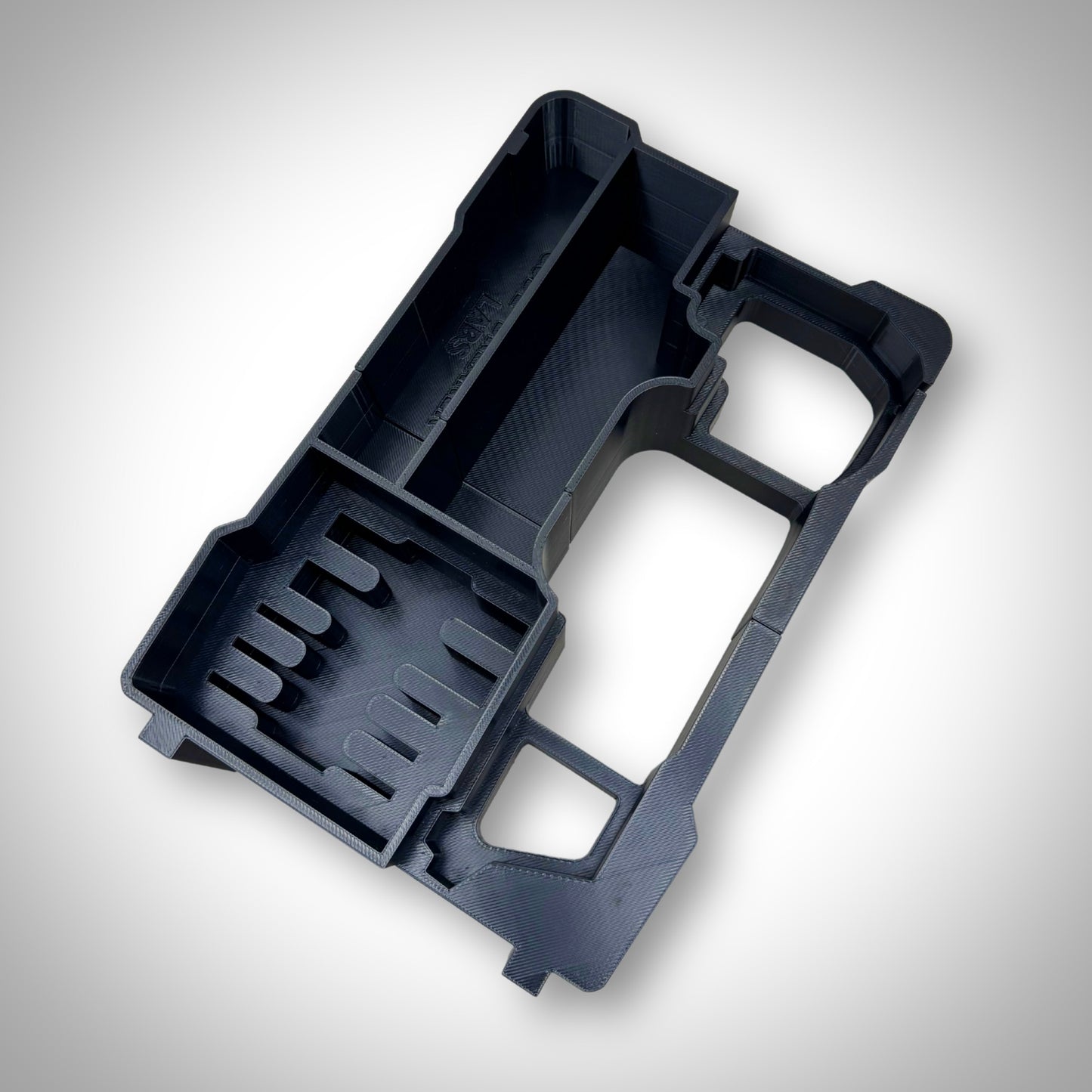 M12 FUEL Multi-Tool Insert displayed outside the PACKOUT™ Compact Organiser, highlighting its precision-cut slots and durable build.