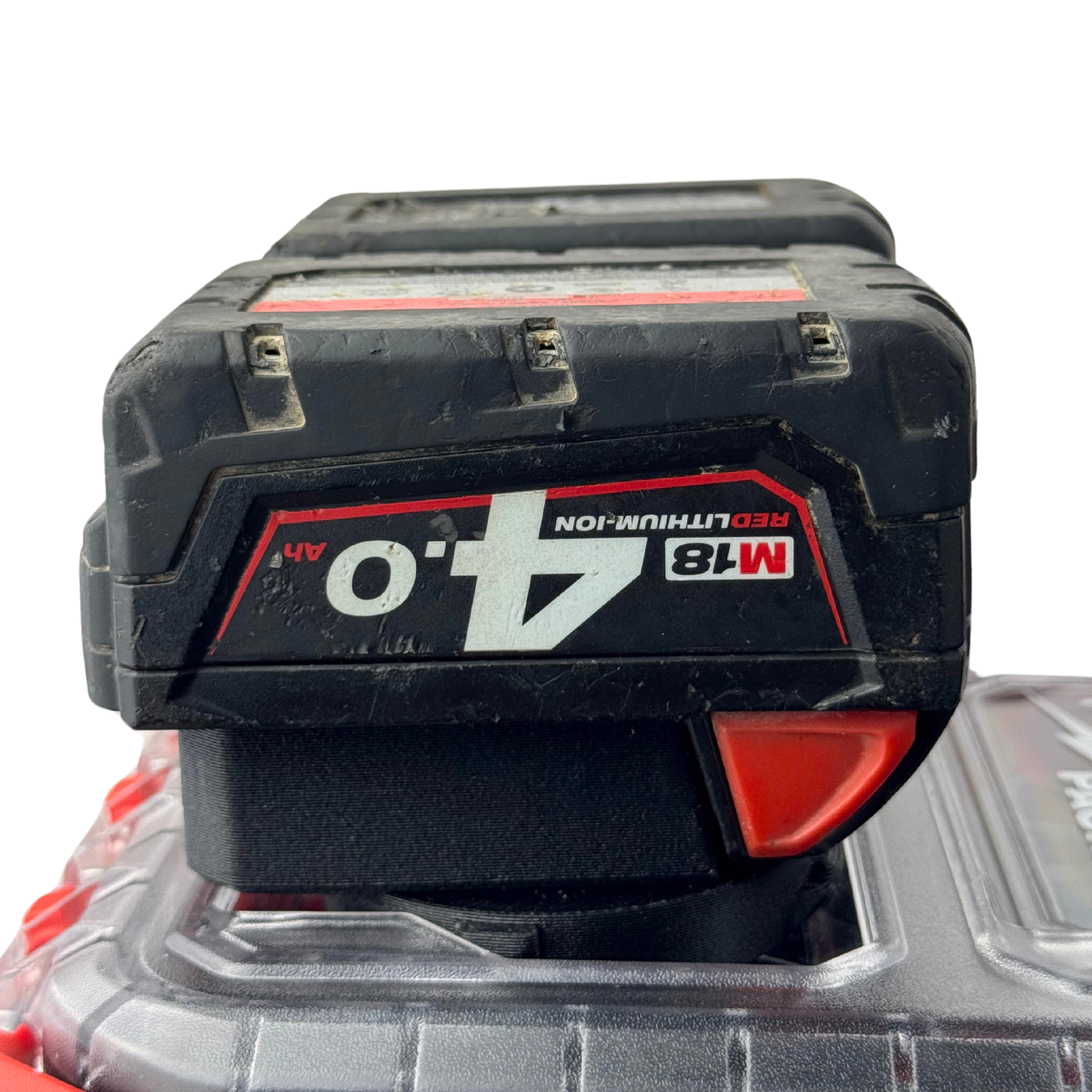 M18 batteries securely fitted into the adapter insert atop a Milwaukee PACKOUT™ Compact Organiser, fully loaded for transport or storage.