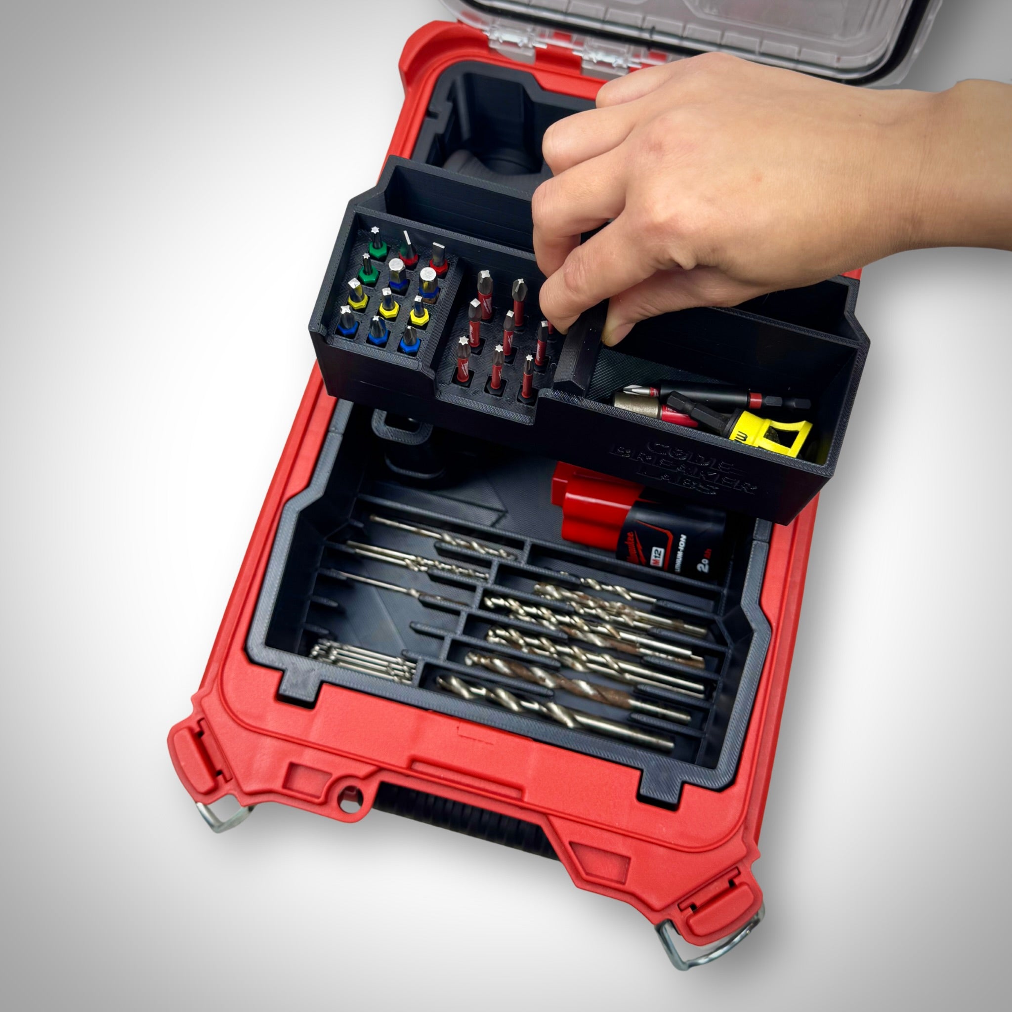 Milwaukee PACKOUT Compact Organiser with Installation Driver insert fully loaded with the driver, heads, and accessories, neatly organized inside the container, with the removable compartment being demonstrated.