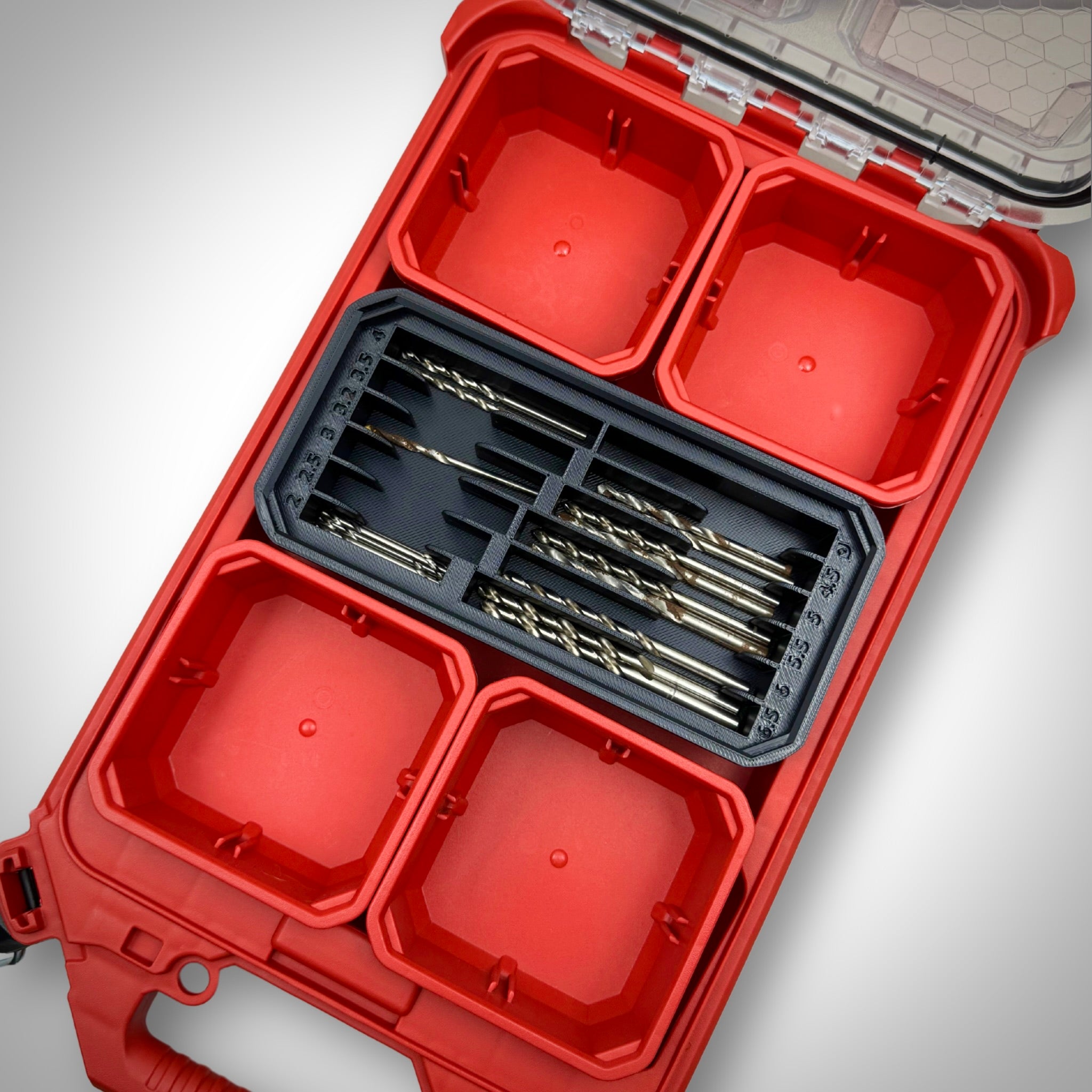 Milwaukee PACKOUT™ Low Profile Organiser with black Metric Drill Bit Holder Insert loaded with assorted metric drill bits, neatly organised inside the toolbox.
