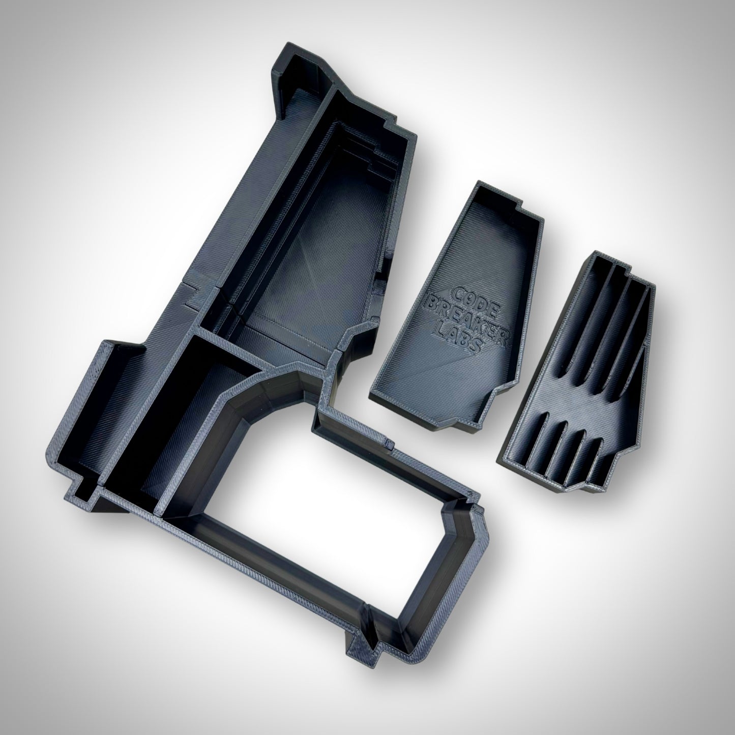 M18 Drill Insert displayed alone, outside the PACKOUT™ Compact Organiser, highlighting its custom-shaped sections and rugged design.