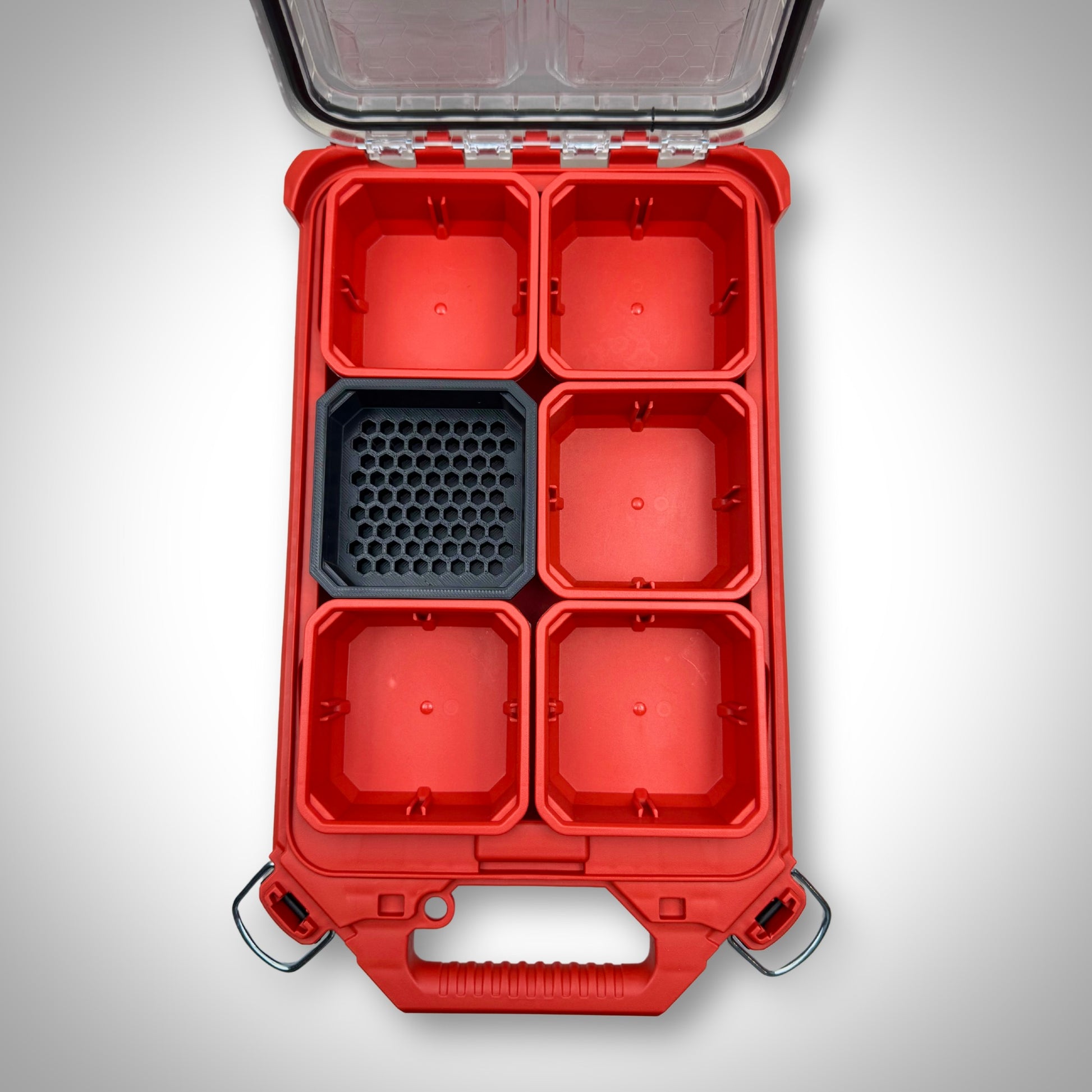 Empty black Hex Bit Holder insert placed inside a Milwaukee PACKOUT™ bin, featuring compartments for 76 hex bits.