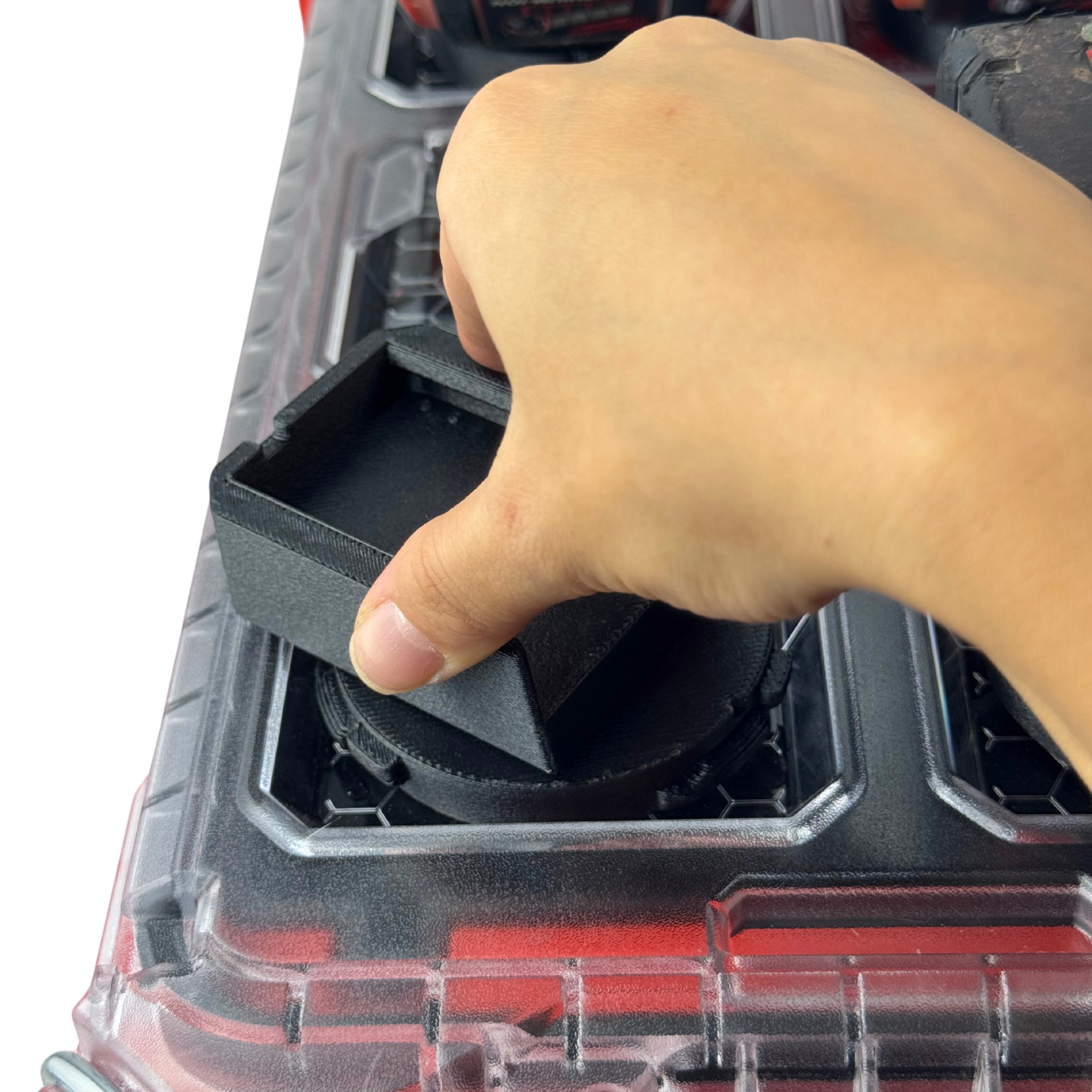A hand showcasing the durable twist lock capability of the M18 battery adaptor
