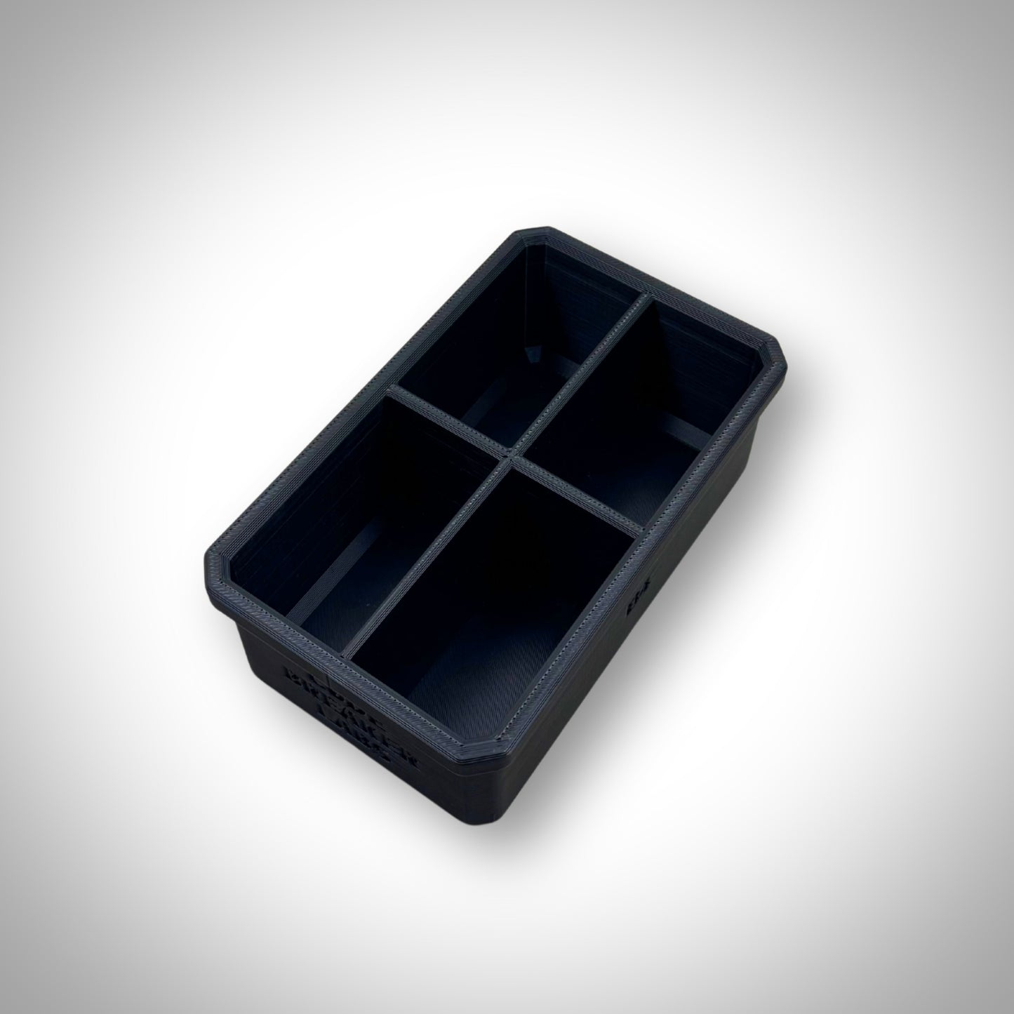Empty Milwaukee PACKOUT™ 4-Way Divider Bin displayed outside the 4-Drawer Toolbox, showcasing four compartments for parts sorting.