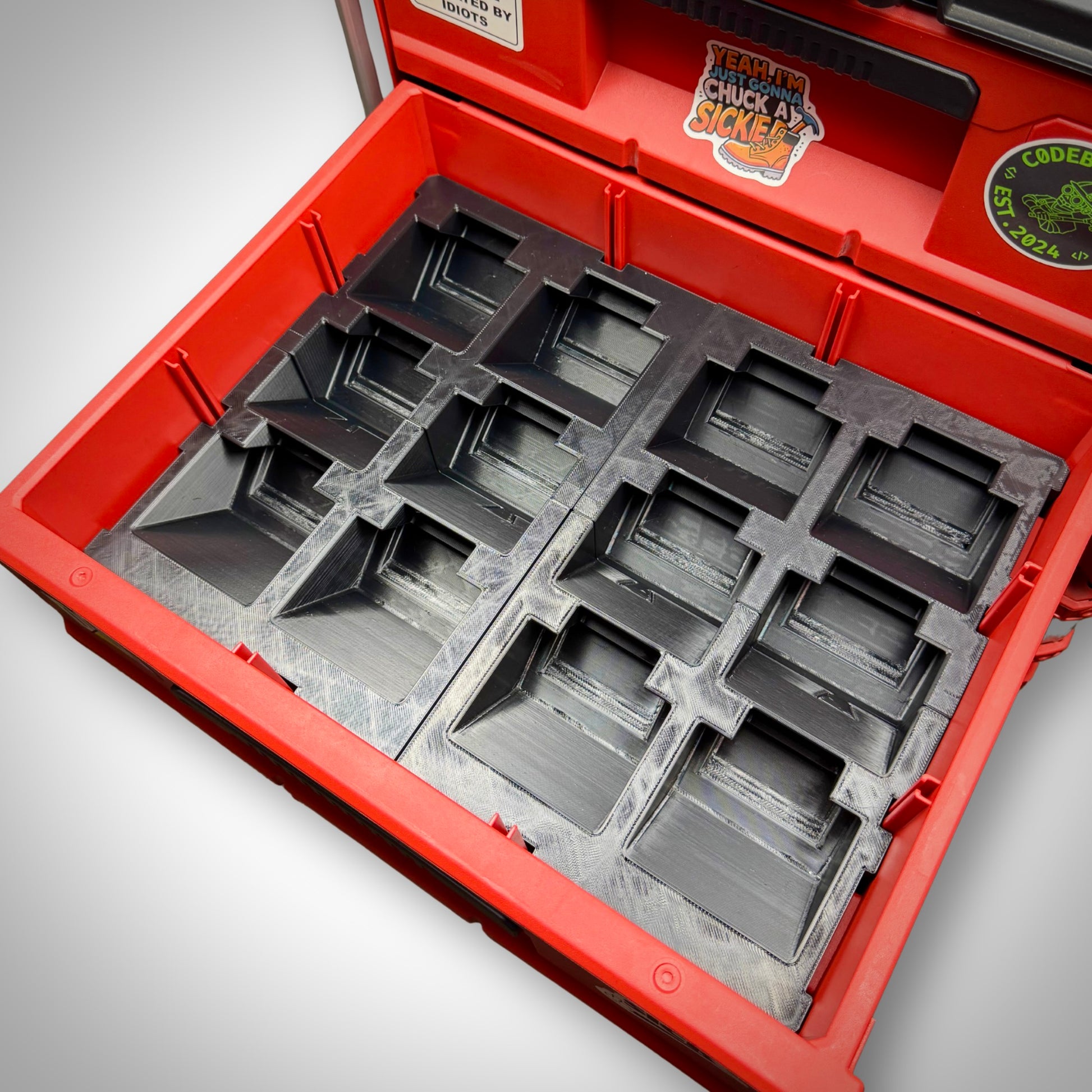 Two Empty M18 Battery Storage Insert seated inside the Milwaukee PACKOUT™ Two-Drawer Toolbox, showing custom-fit compartments ready for batteries.