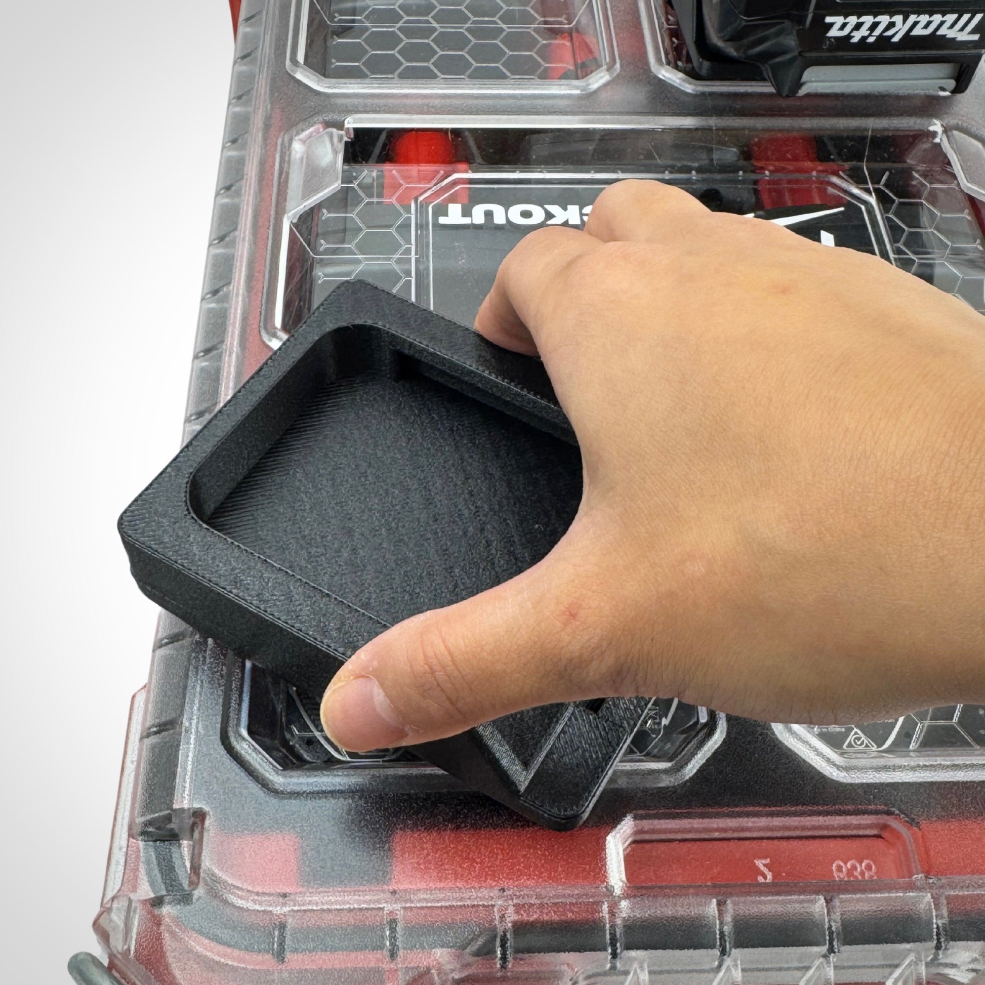 Hand showcasing the twist lock capability of the Makita 40V battery adaptor for the PACKOUT