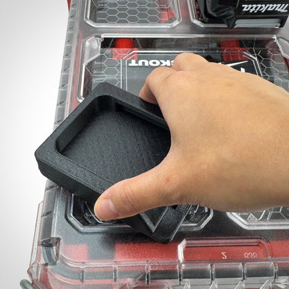 Hand showcasing the twist lock capability of the Makita 40V battery adaptor for the PACKOUT