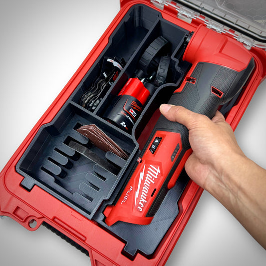Hand lifting the M12 FUEL Multi-Tool from the insert inside the PACKOUT™ Compact Organiser, demonstrating quick and easy access.