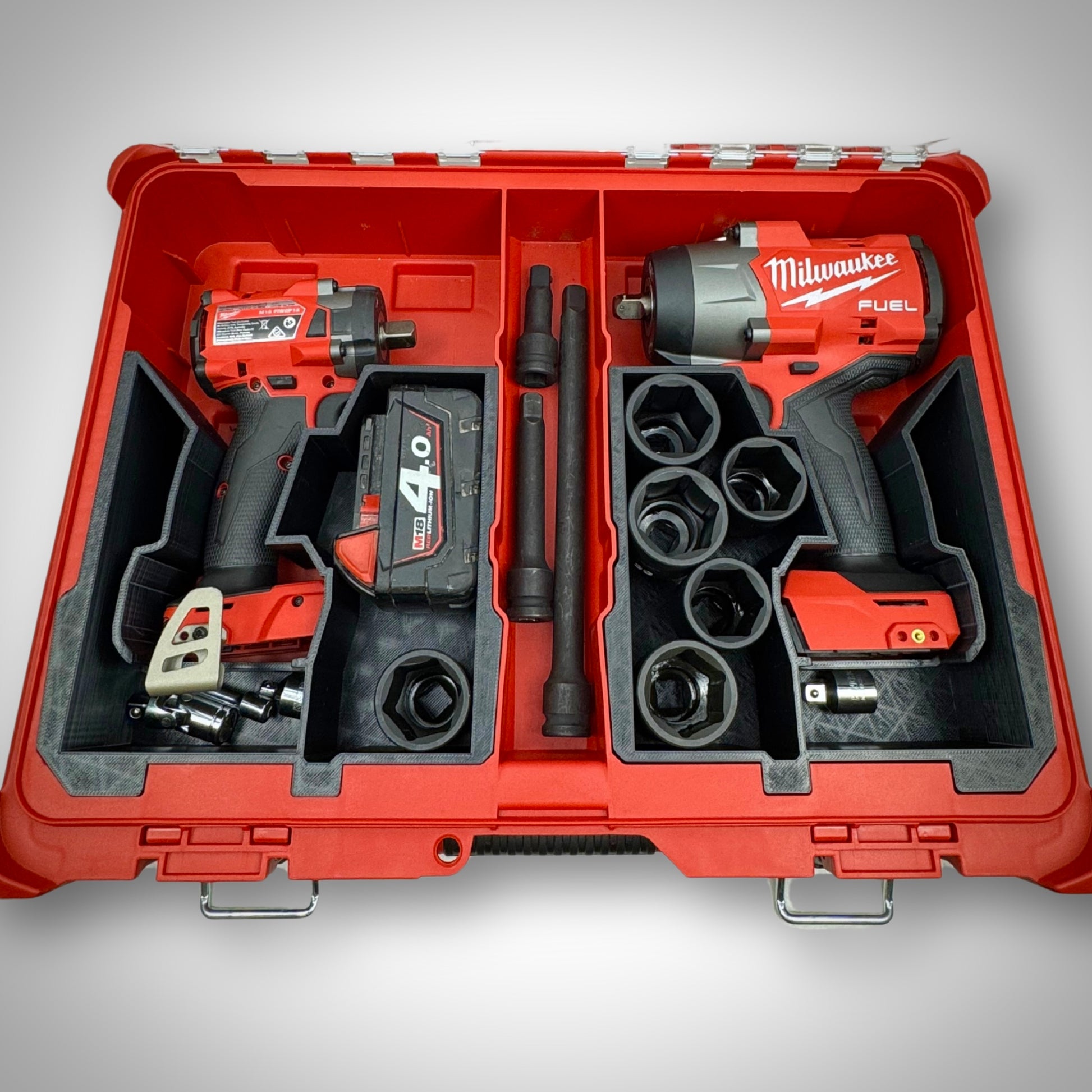 Impact wrench, multiple M18 batteries, and accessories securely arranged in both the left and right version of the custom insert within the Milwaukee PACKOUT™ Organiser 