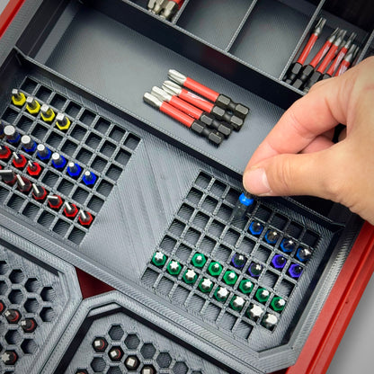Hand reaching into the PACKOUT™ Low Profile Organiser to grab a bit from the Impact Bit Organiser Combo insert, demonstrating smooth, organised access to all bits.