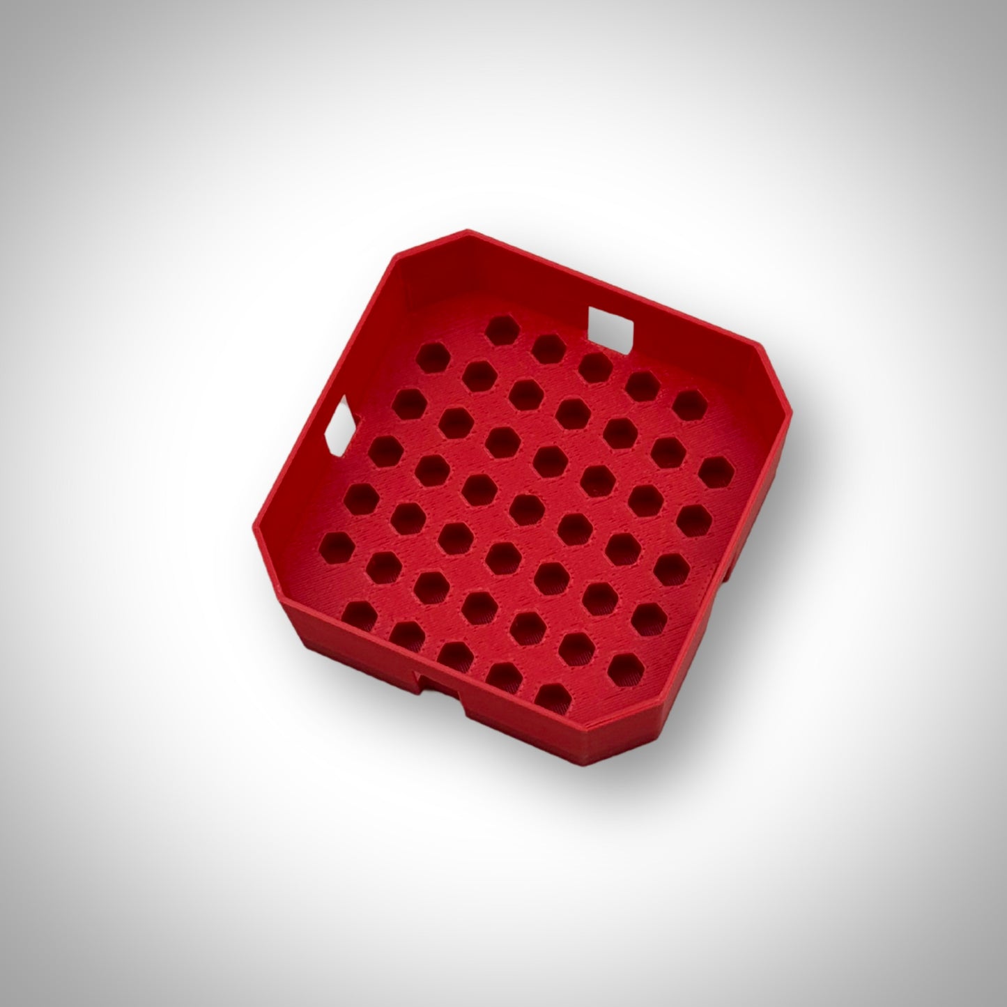 Red Milwaukee PACKOUT™ Low-Profile Bit Holder Insert displayed outside the PACKOUT™ bin, showcasing its compact and sturdy layout.