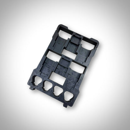 Empty black M12 Battery Storage Insert displayed outside the Milwaukee PACKOUT™ Compact Organiser, highlighting its sturdy design and perfect fit.