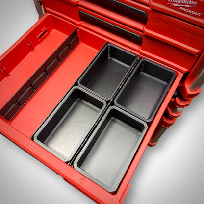 Four empty Milwaukee PACKOUT™ Full Bins arranged side by side inside the 4-Drawer Toolbox, ready for large item storage.