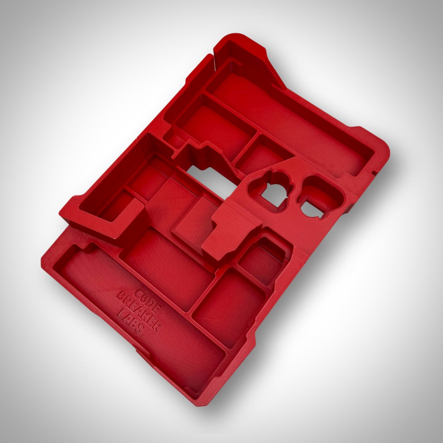 Red insert displayed on its own, outside of the PACKOUT™ box, with visible cutouts for the M12 tool set and accessories.