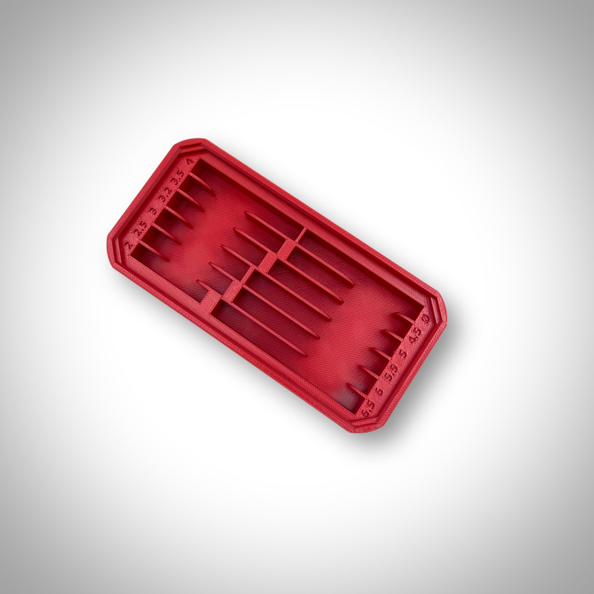Empty red Metric Drill Bit Holder Insert displayed outside the Milwaukee PACKOUT™ Low Profile Organiser, highlighting its durable design and precision moulding.