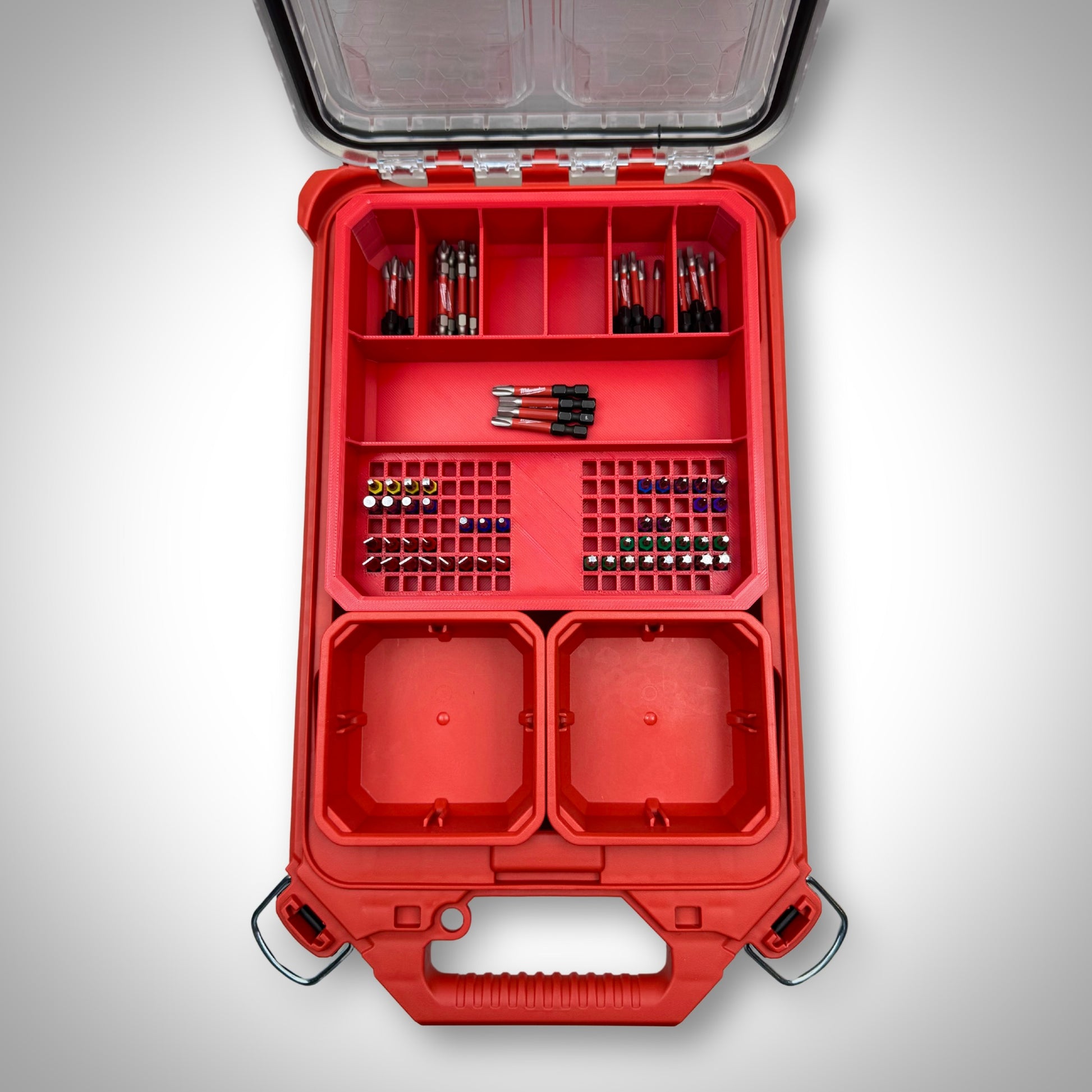 Milwaukee PACKOUT™ Low Profile Organiser featuring the red Impact Bit Holder V2 fully loaded with 50mm bits and extension bits, neatly arranged inside the toolbox.
