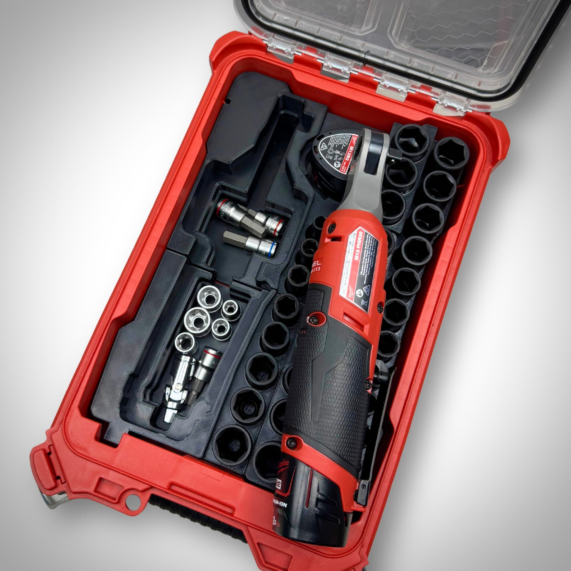 Milwaukee PACKOUT™ Compact Organiser with M12 Ratchet & 3/8" Socket Set Insert fully loaded with ratchet, sockets, and accessories, neatly organized inside the toolbox, with the ratchet moved to the side revealing more storage underneath.