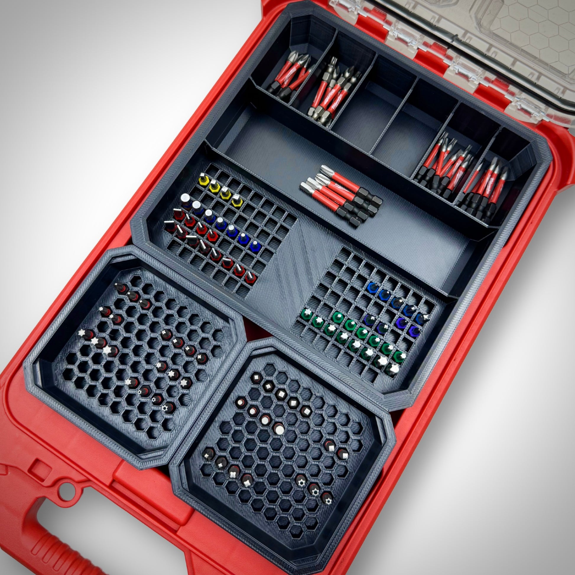 Milwaukee PACKOUT™ Low Profile Organiser loaded with the Impact Bit Organiser Combo insert, holding an assortment of 25mm, 50mm, and extension bits neatly arranged in designated compartments.