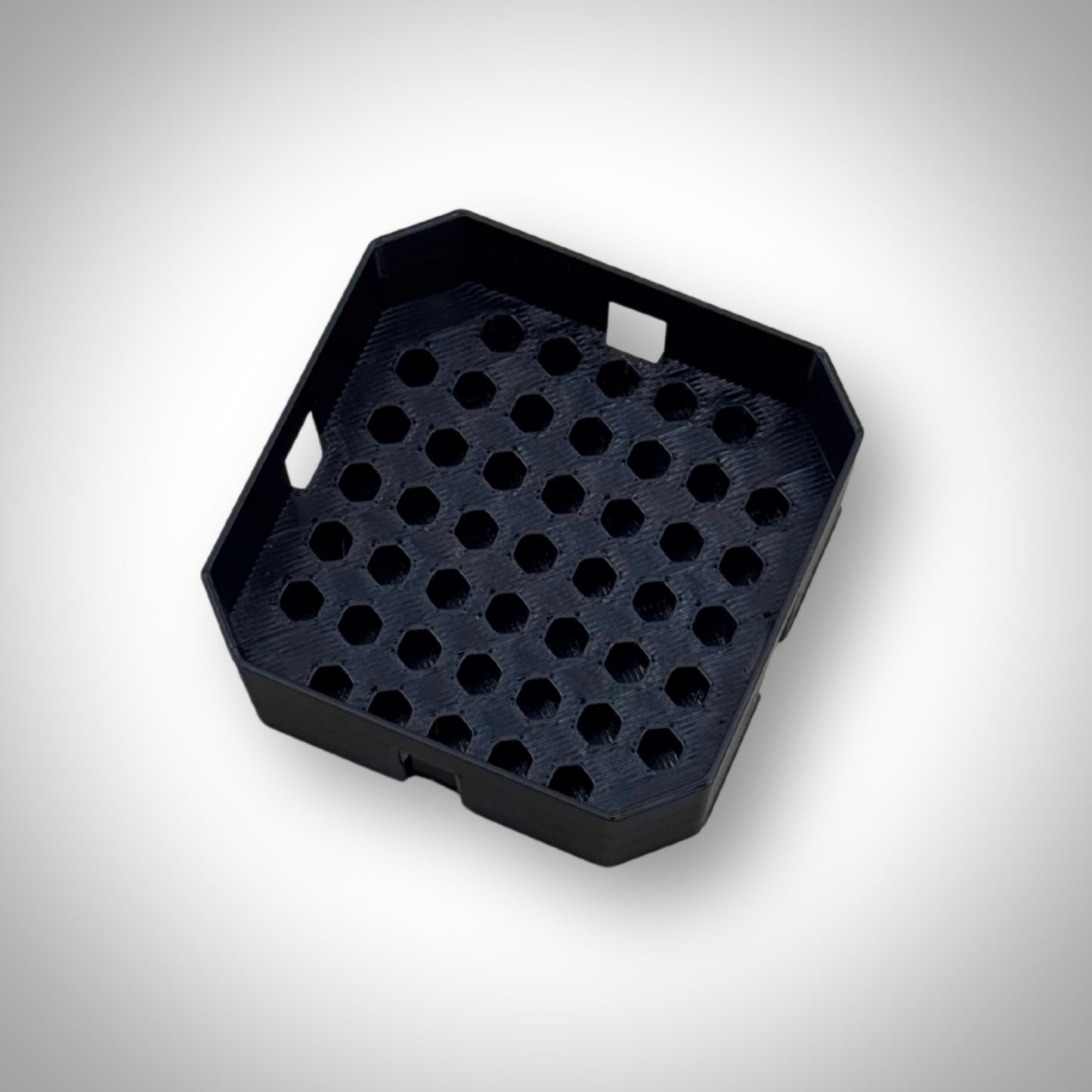Black Milwaukee PACKOUT™ Low-Profile Bit Holder Insert displayed outside the PACKOUT™ bin, highlighting its durable construction and slim profile.