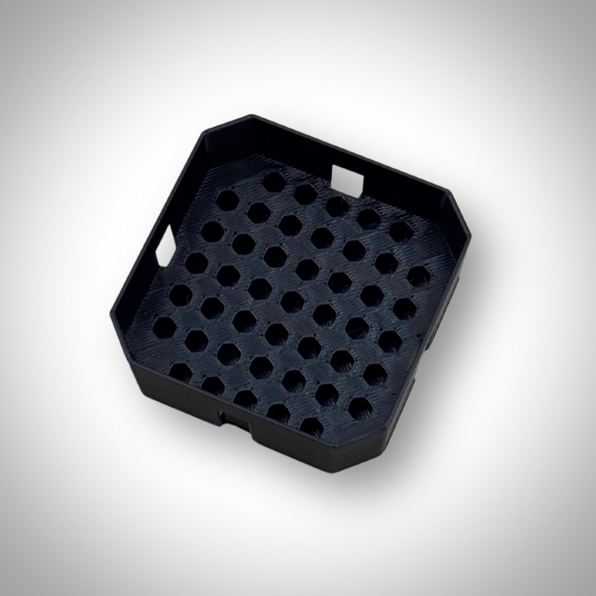Black Milwaukee PACKOUT™ Low-Profile Bit Holder Insert displayed outside the PACKOUT™ bin, highlighting its durable construction and slim profile.