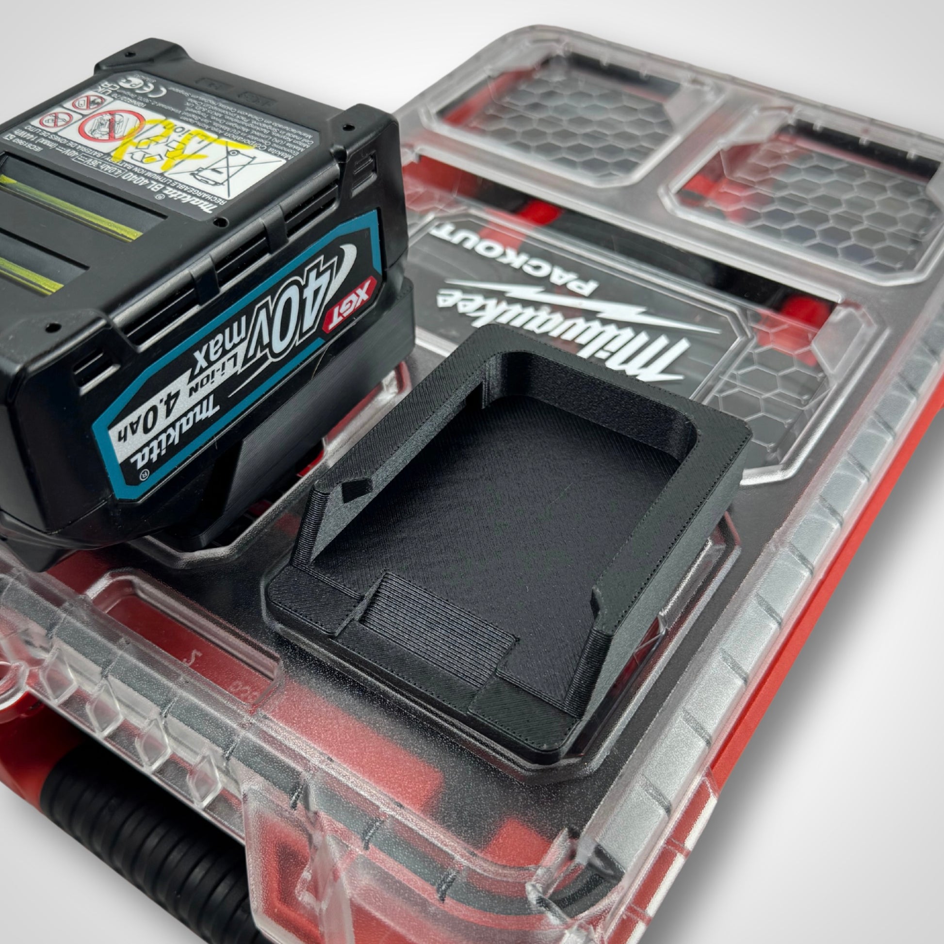 Empty Makita 40V adaptor insert fitted on top of the PACKOUT™ Compact Organiser, compartments clearly defined and ready for loading.