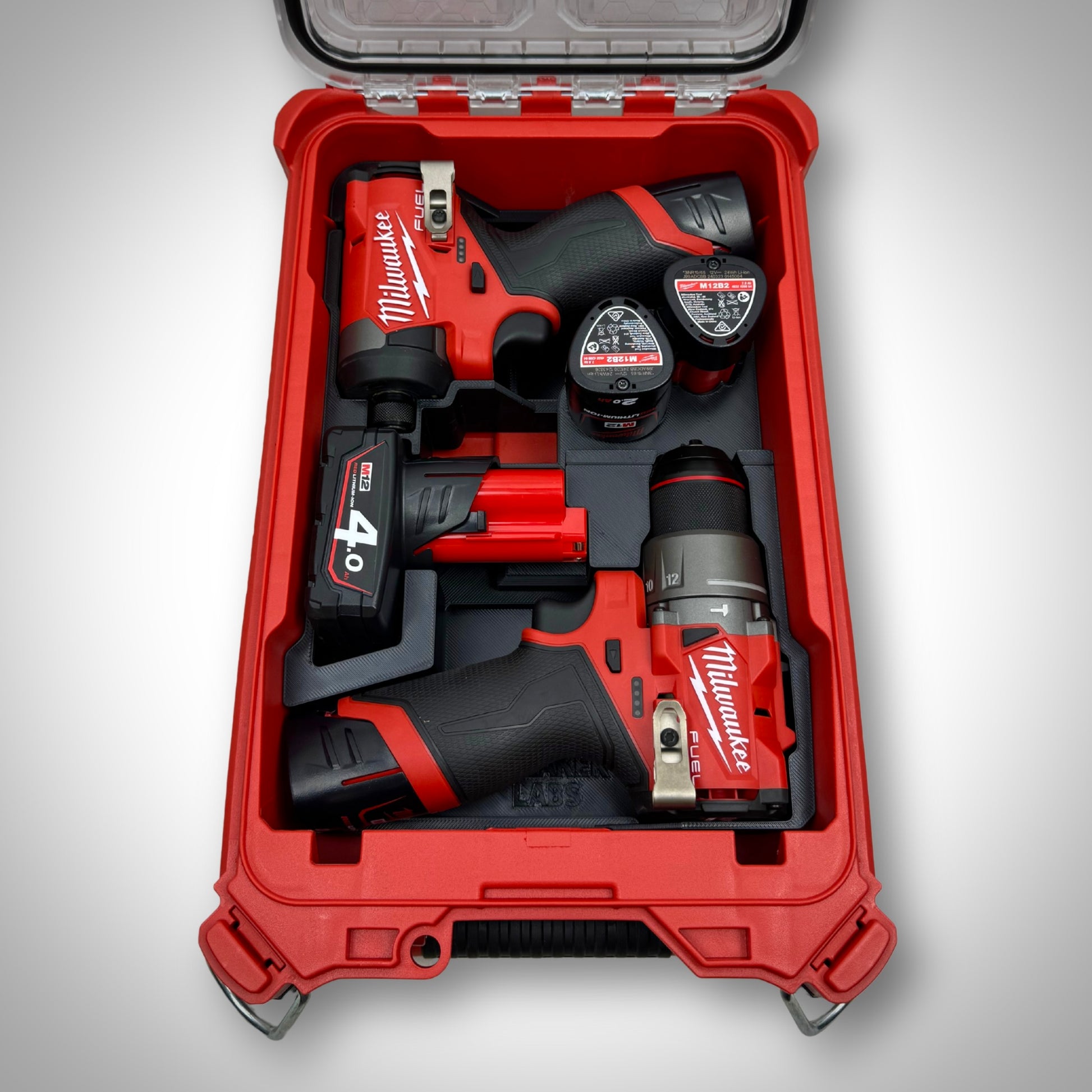 M12 Hammer Drill, M12 Impact Driver, batteries, and bits neatly organized in the custom insert inside the Milwaukee PACKOUT™ Compact Organiser.