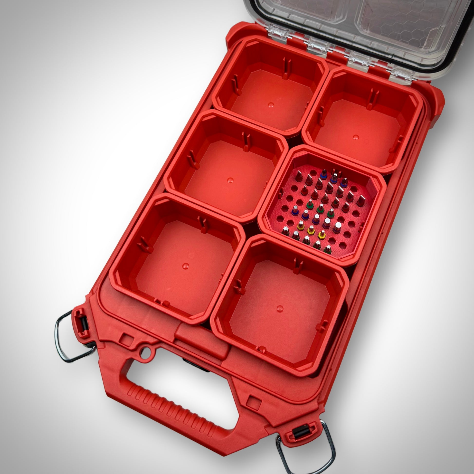 Red Milwaukee PACKOUT™ Low-Profile Bit Holder Insert fully loaded with impact bits, securely fitted inside a PACKOUT™ bin.