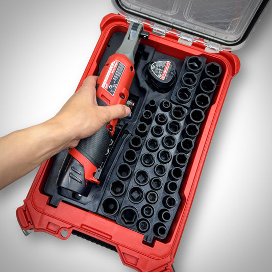 Hand lifting the M12 ratchet from the fully loaded M12 Ratchet & 3/8" Socket Set Insert inside the Milwaukee PACKOUT™ Compact Organiser, showcasing easy access to tools.