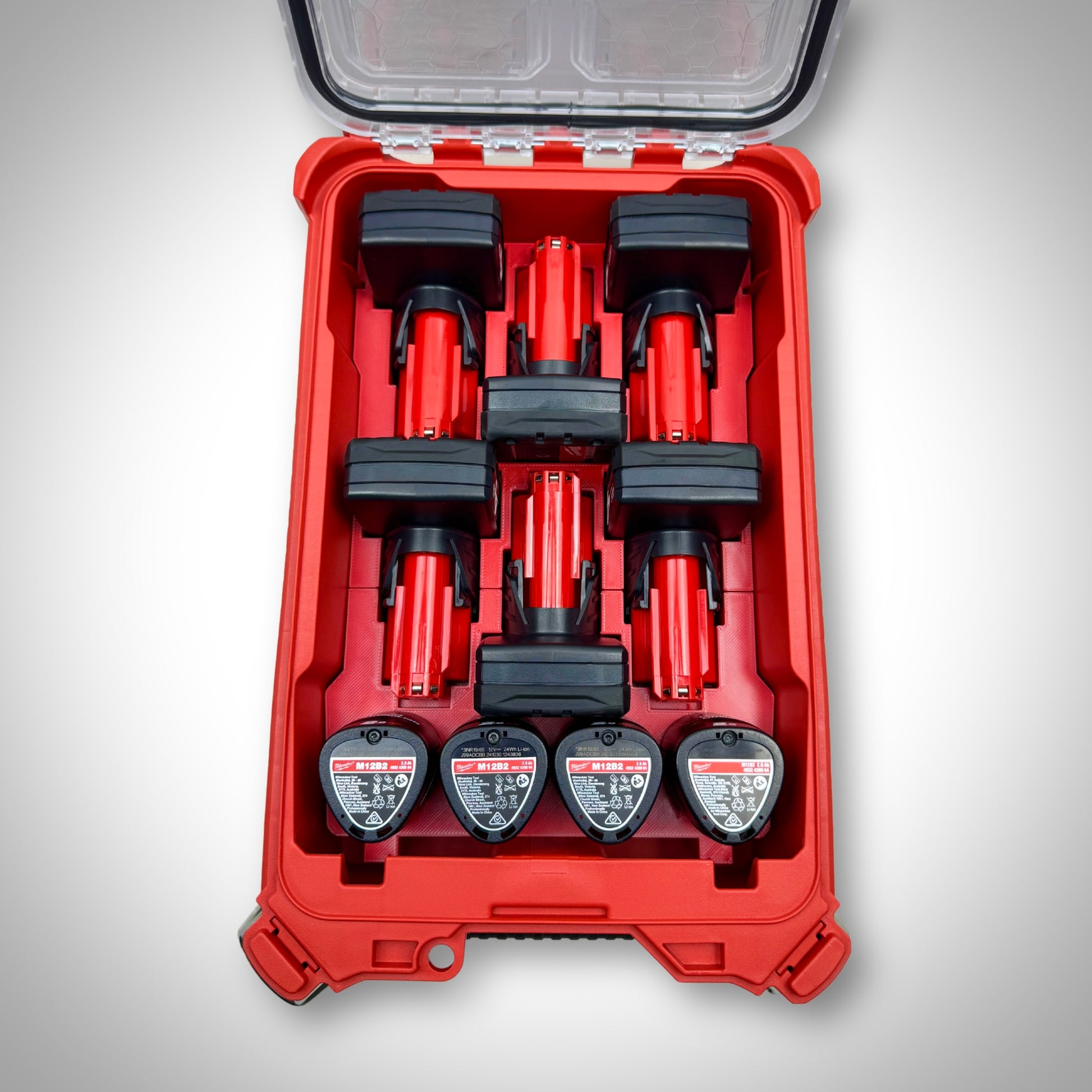 Milwaukee PACKOUT™ Compact Organiser with red M12 Battery Storage Insert fully loaded with M12 compact and extended batteries, neatly organised inside the toolbox.
