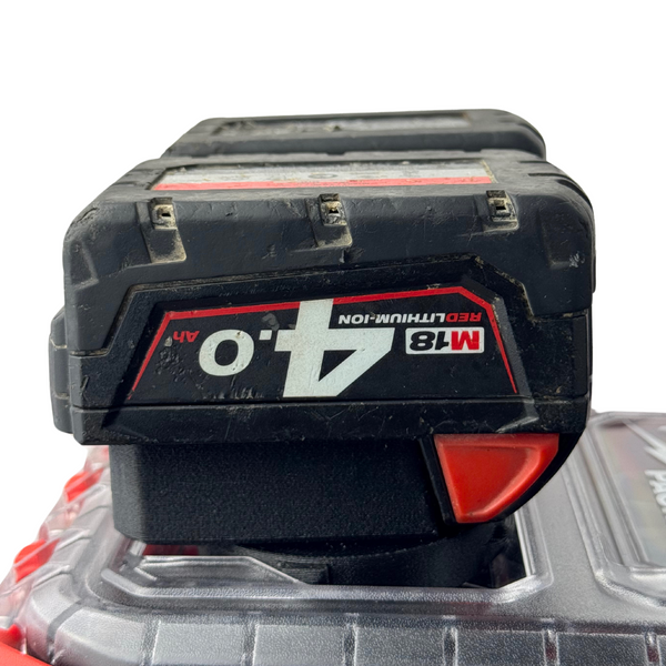 M18 batteries securely fitted into the adapter insert atop a Milwaukee PACKOUT™ Compact Organiser, fully loaded for transport or storage.