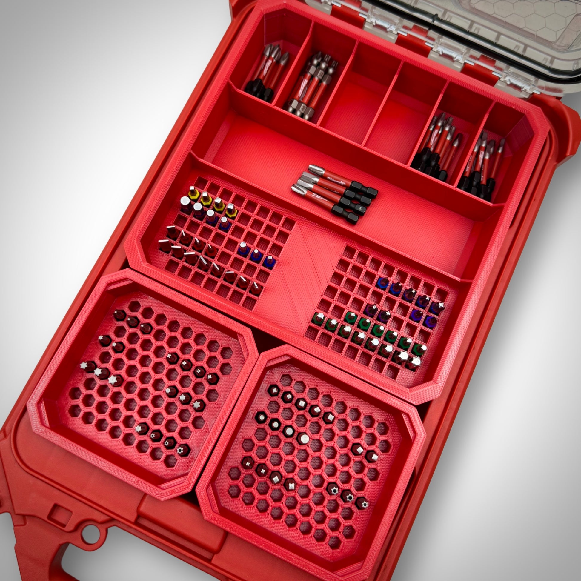 Red Impact Bit Organiser Combo insert loaded with assorted impact bits inside a Milwaukee PACKOUT™ Low Profile Organiser, showing a bold, clean layout.