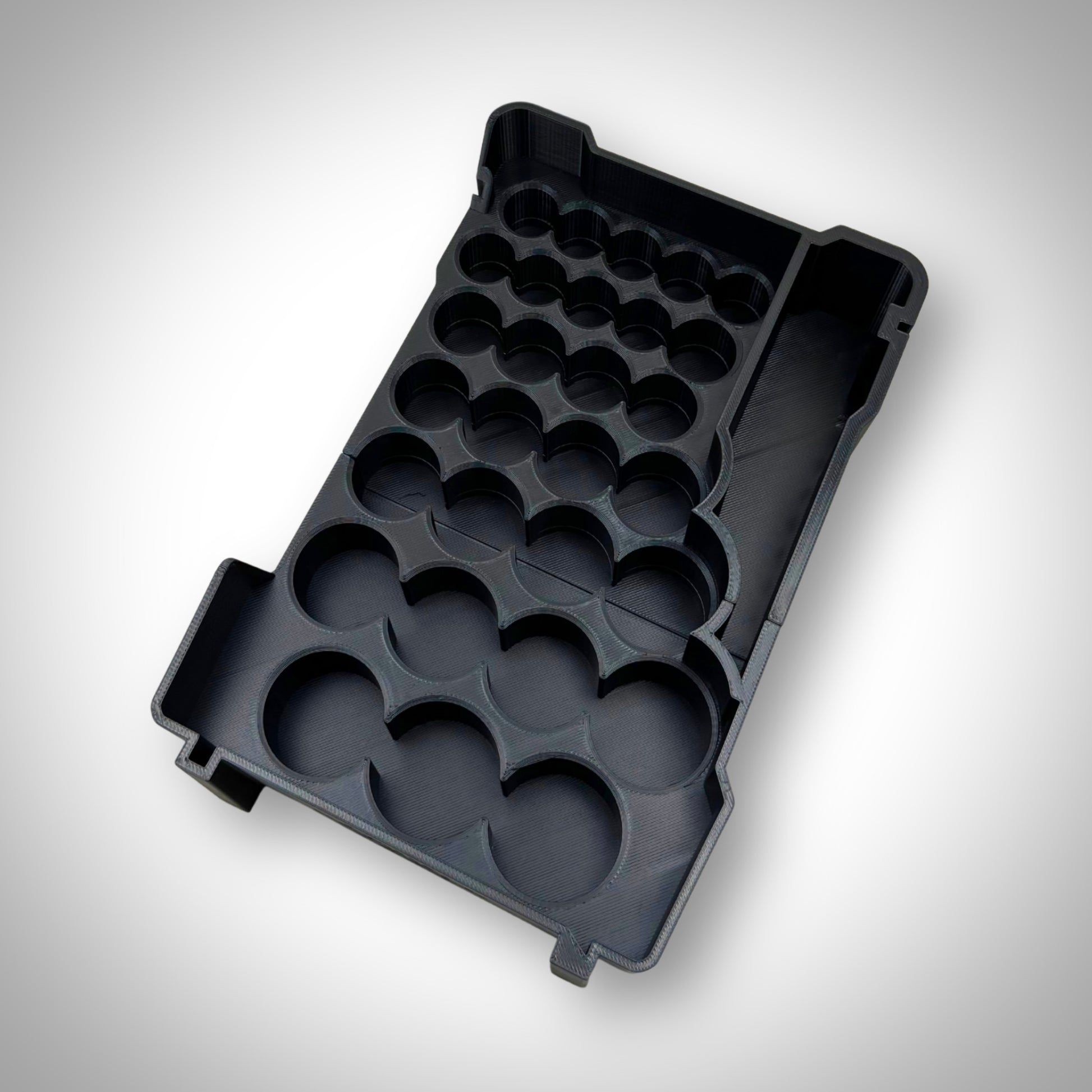 Empty metric socket organiser insert displayed outside the Milwaukee PACKOUT Toolbox, showing precise socket grid layout and durable construction