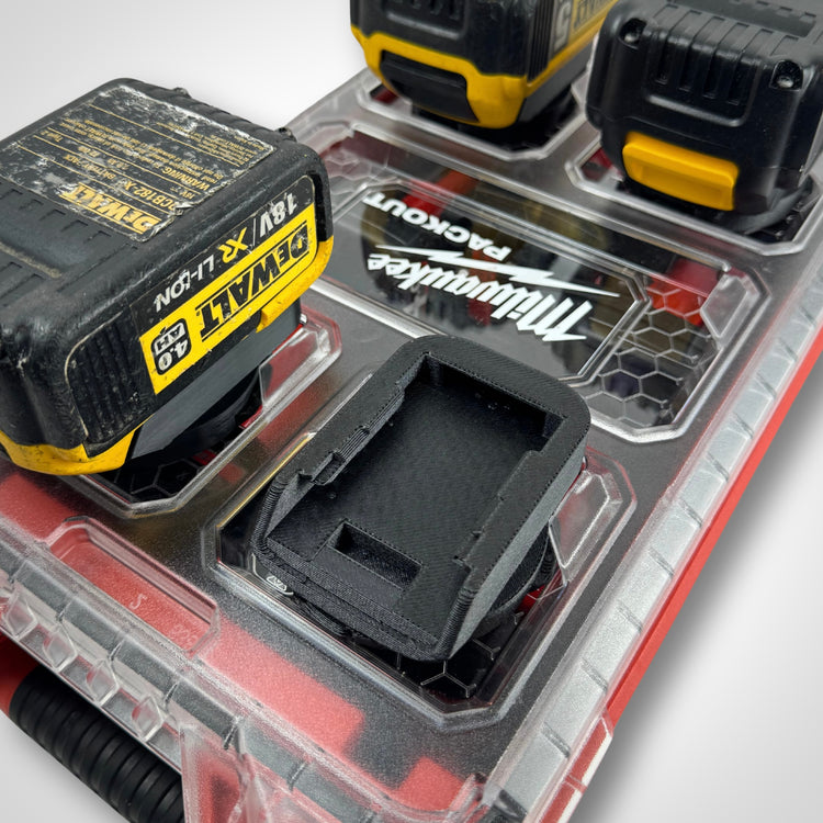 Adaptor insert placed on the PACKOUT™ Compact Organiser, compartments visible and empty, designed specifically for DeWalt 18V batteries.