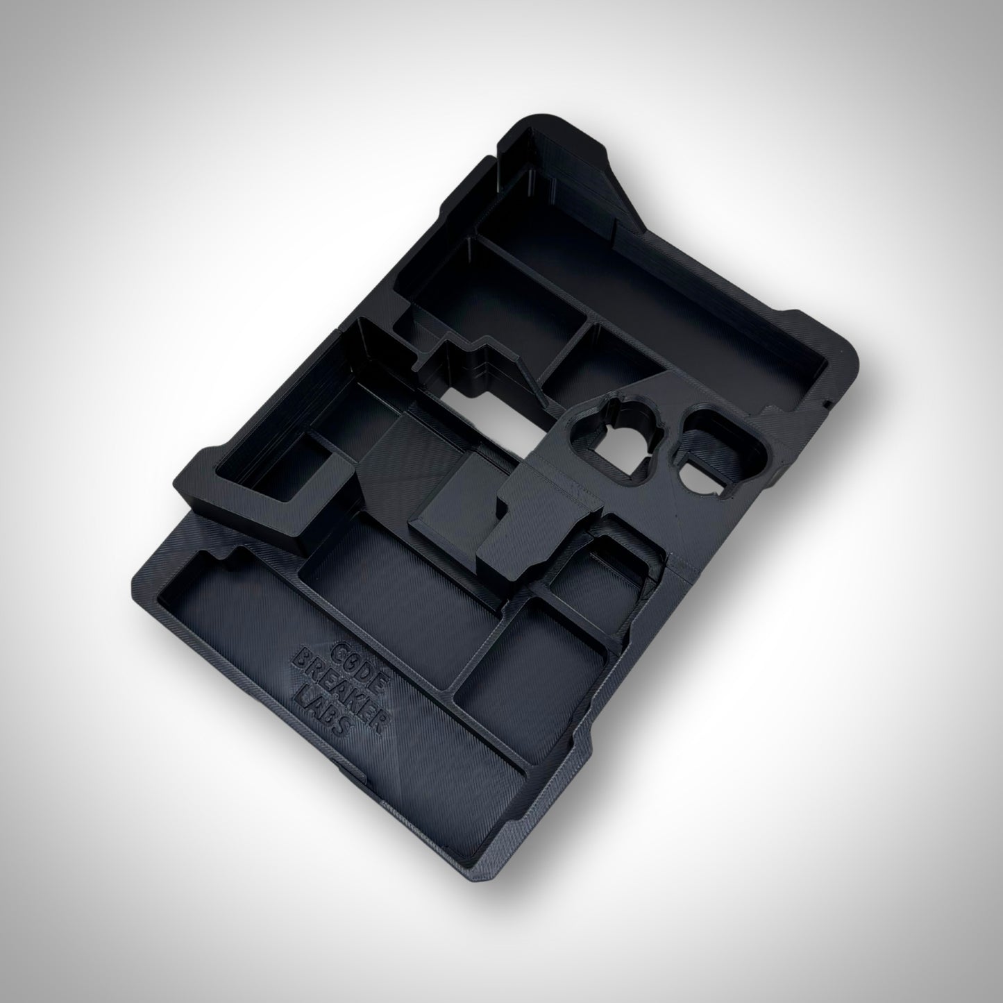 Custom insert shown outside of the PACKOUT™ box, with clearly defined cutouts for M12 tools, batteries, and accessories.