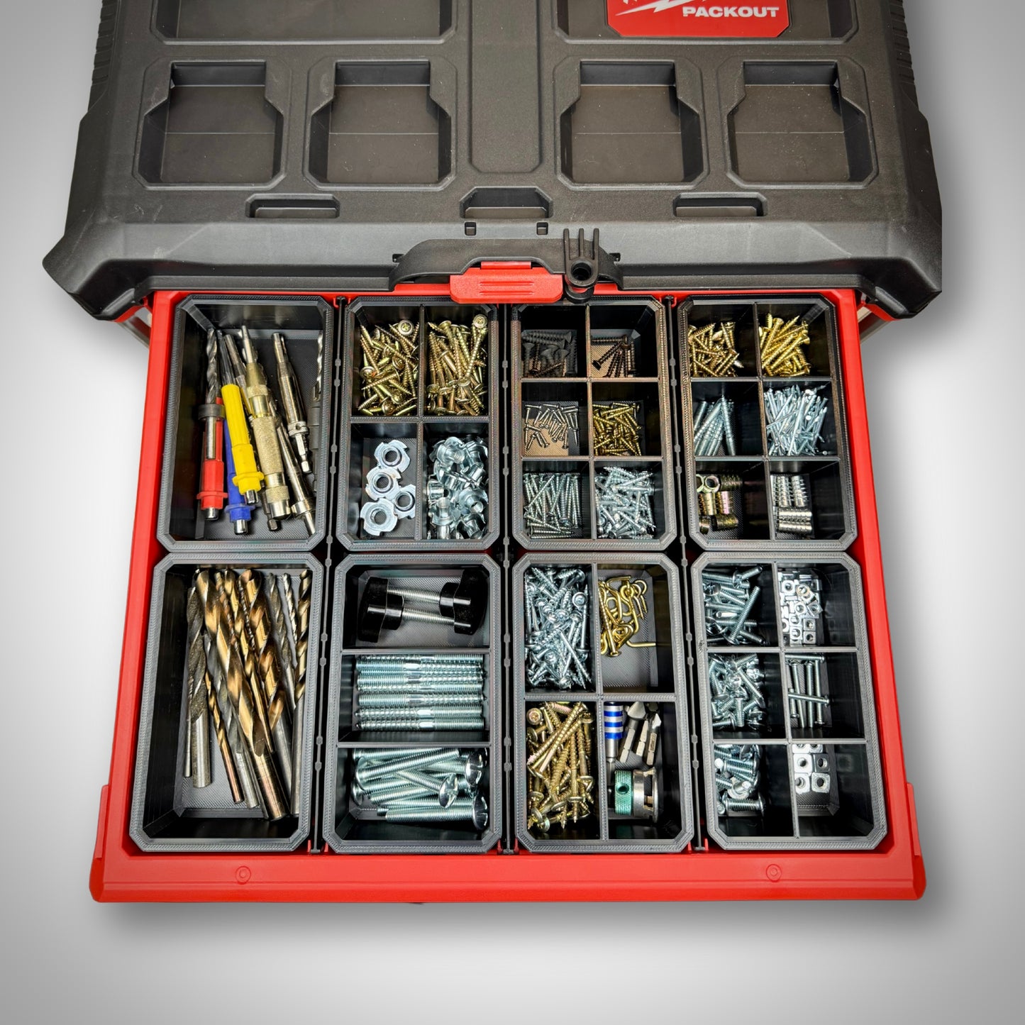 Milwaukee PACKOUT™ 4-Drawer Toolbox loaded with mixed divider bins loaded with different accessories.