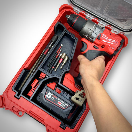 Hand lifting the M18 drill from the insert inside the PACKOUT™ Compact Organiser, demonstrating convenient access to tools.